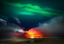 Northern lights dancing above an erupting volcano on the Reykjanes peninsula in Iceland.Picture: Paul Mortz, Press Camera Club