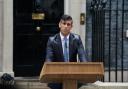 PM Rishi Sunak outside Downing Street announces the election date in a rain storm on Wednesday