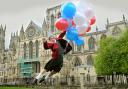Minster School pupil Grace Gledden “takes off” to promote the balloon race