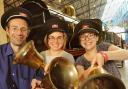 National Railway Museum staff, from left, Tim Procter, Ellen Tait and Anna Pinkstone prepare to “ring in” the Olympic celebrations