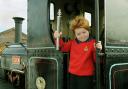 Six-year-old Charlie Holtby, of the Boys' Brigade 1st Acomb Company, holding the Baton, during the handover at the National Railway Museum, on the footplate of steam locomotive Lilla