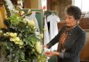 Mary Masefield puts the finishing touches to a flower display