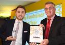 Ian Jones, left, receives his Charity Fundraiser of the Year award from Ian Pryer, of sponsors Pryers