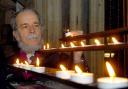 John Bibby, currently on hunger strike in York Minster, lights a candle
