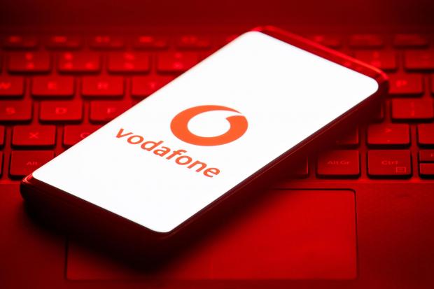 York Press: Vodafone logo on a phone placed on a keyboard. Credit: PA