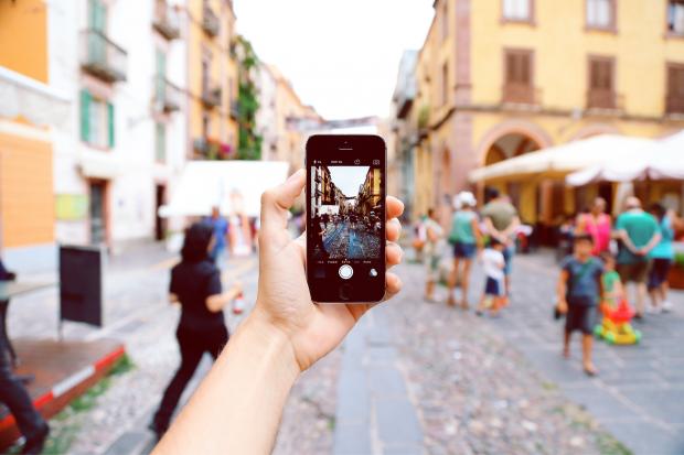 York Press: A tourist taking a picture of a busy street on their phone. Credit: Canva