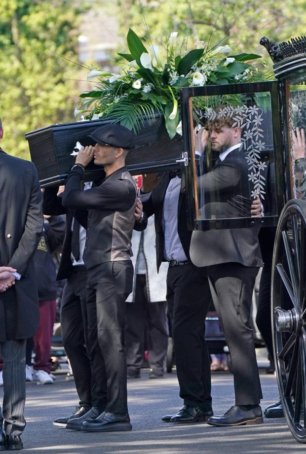 York Press: Max George and Jay McGuiness of The Wanted carry the coffin at the funeral of their bandmate. (PA)