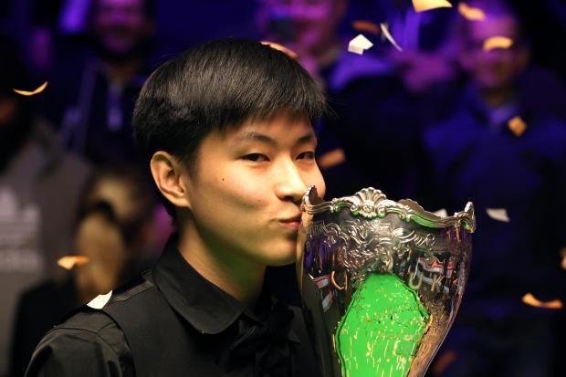 Zhao Xintong kisses the trophy after winning the Cazoo UK Snooker Championship at the York Barbican. Picture: Richard Sellers/PA Wire