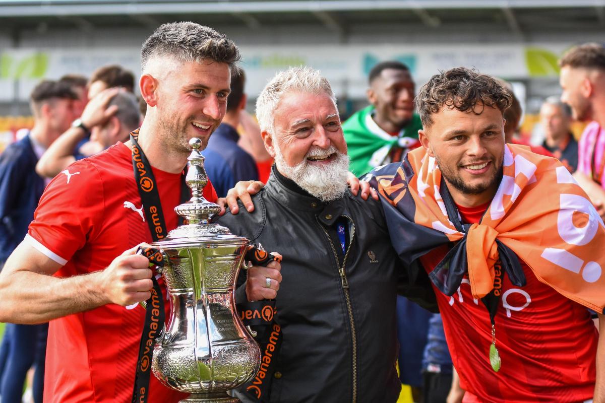 York City chairman Jason McGill (centre) poses with the Vanarama National League North play-off final trophy alongside players Paddy McLaughlin (left) and Kurt Willoughby (right). Picture: Tom Poole