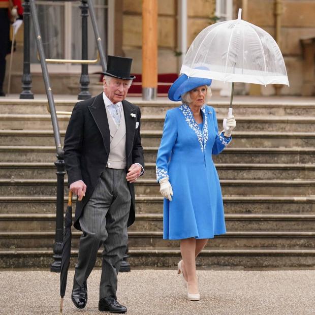 York Press: The Prince of Wales and the Duchess of Cornwall during a Royal Garden Party at Buckingham Palace. Picture: PA