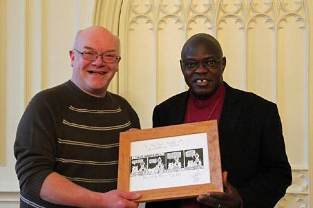 Richard Stansfield presenting a framed Yorkatt and Eric cartoon to the Archbishop of York, Dr John Sentamu, in January 2013