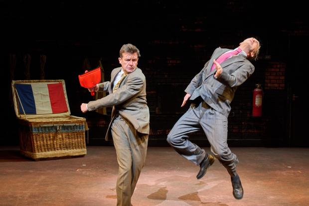Slap-stick: The dustpan-wielding Thom Tuck left has a dust-up with double-act partner Dennis Herdman in The Play What I Wrote. Picture: Manuel Harlan