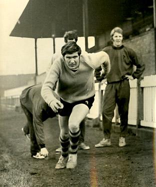 09/12/70: Archie Taylor sprinting down the track against the clock as skipper Barry Swallow looks on, as York City continue training for cup tie against Boston.