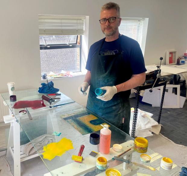 York Press: • Russell Hughes printing in his ‘pop up’ studio in an empty York office Picture: York Printmakers