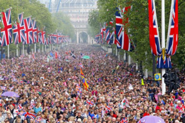 Crowds of well-wishers are led down The Mall, London, towards Buckingham Palace, following the royal      wedding at Westminster Abbey