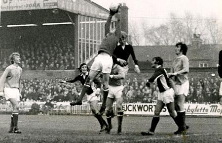 21/11/73 - York City 0, Manchester City 0, League Cup 4: 'Keeper Keith McRae reaches high to rob Barry Swallow in the crowded penalty area.