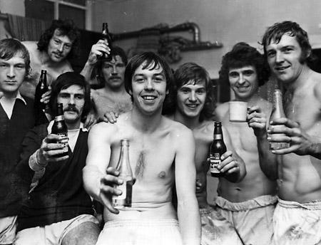 The team celebrate promotion in the dressing room.