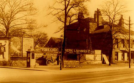 This picture was taken in 1927 in Blossom Street. Ten years later, the Odeon Cinema was built here. The land was the garden of the house, which in this picture was partly occupied by the Crescent Cafe.