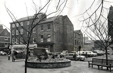 King's Square in 1966 showing a large gap in the row of houses and shops in Colliergate which motorists used as a car park. 
