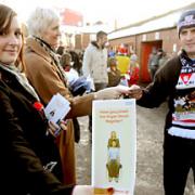 Megan Thomas, left, and Tania Sinclair, mother of Sam Sinclair, hand out organ donor registration cards before York City’s game against Mansfield