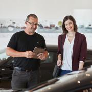 Adrian Hogarth, in the showroom of SPC Cars, with a client  Picture: Olivia Brabbs