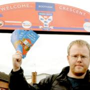 The Press news editor, Gavin Aitchison, hands out organ donor leaflets outside Bootham Crescent after the match against Altrincham
