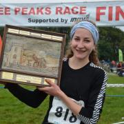 York Knavesmire Harriers’ new recruit Rose Mather celebrates being the first lady back at the Yorkshire Three Peaks race
