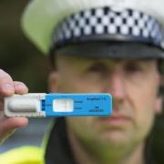 A police officer with a roadside drug test