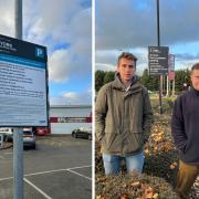Cllrs Darryl Smalley (right) and Derek Wann (far right) at Clifton Moor Retail Park with a parking restriction sign (left)