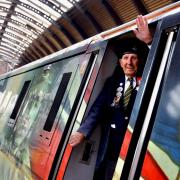Normandy veteran Ken Cooke waving from the cab of LNER's ''For The Fallen' locomotive no 91111 after it arrived at York Railway Station today