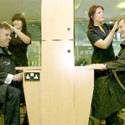 The MPs have their hair cut by York College apprentices Lauren Creaser, left, and Imogen Watson