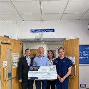 Geoff Ashworth with the fundraising cheque at the Head and Neck department in York Hospital