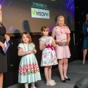 Sarah Bennett from Visavvi presenting the Child of the Year award to Erica Reynolds, Billie Grace Bowater and Scarlett Walker