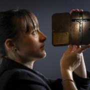 Special collections manager Dr Hannah Thomas holds a crucifix, the only known item to survive of the thousands seized during the raids on Catholic houses following the discovery of the Gunpowder Plot in 1605. Picture: PA