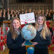 Wensleydale School students Millie Gilbey and Jessica Arnott with their school’s globe at the annual service children's Remembrance Service