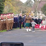 A child lays a wreath after the annual Remembrance Service at York's war memorial