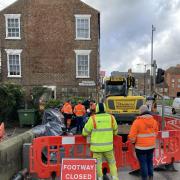 Workmen laying sandbags at the entrance to Tower Gardens in York