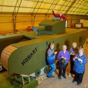 (L to R) Lynn Hart, Hazel Barker, Carol Dunkley, Sandra Searle and Stuart Martin beside the knitted tank. Picture: SWNS