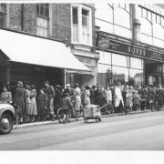 The queue in the 1950s for the Bridge Street branch of York butchers Wrights - with a Jowett Javelin peeping into shot on the left