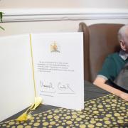 Ken Holmes with his special birthday message from the King and Queen