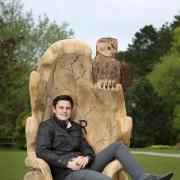 Jonathan Sherwood with his carving of a royal throne