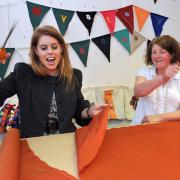 Princess Beatrice tries her hand at pattern cutting as she cuts her way through material for an angel costume at the York Mystery Plays’ costume workshop, watched by community costume supervisor Janet Hull