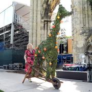 Jo Keogh, a member of the backstage production team, wheels away a topiary giraffe from the set of the Mystery Plays after the last performance