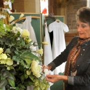 Mary Masefield puts the finishing touches to a flower display