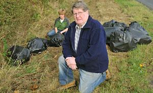 Coun John Galvin and his grandson Edward Matthews with some of the bags of rubbish which were dumped at the side of the road in Bishopthorpe