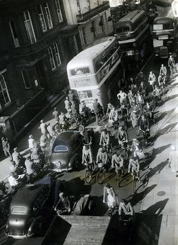 1955 - Cyclists and motorists compete for space in Museum Street. 