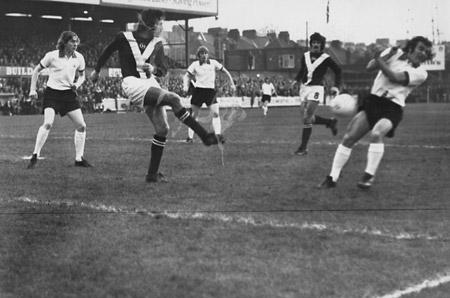 21/12/74 - York City 0, Manchester United 1: Chris Topping, who did some solid defensive work against Manchester United, clears as United's £200,000 player Lou Macari ducks out of the way.