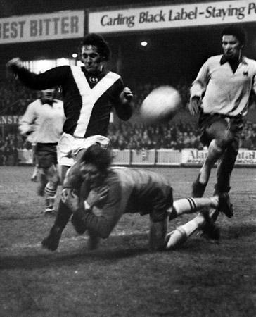 01/11/74 - York City 0, Orient 1: It appears to be a great tackle, Rugby League style. But, actually, Orient 'keeper Jackson was diving in a vain attempt to stop City's Micky Cave getting in a shot during the Second Division match at Bootham Crescent.