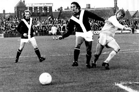 27/08/74 - York City 1, Cardiff City 0: York's Micky Cave slides the ball through for Ian Holmes to go for goal in the game against Cardiff City.