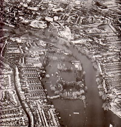 An aerial view of a city under siege, with Rowntrees Park and St George's Field under water 